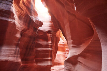 picture of a slot canyon with the sun shining in